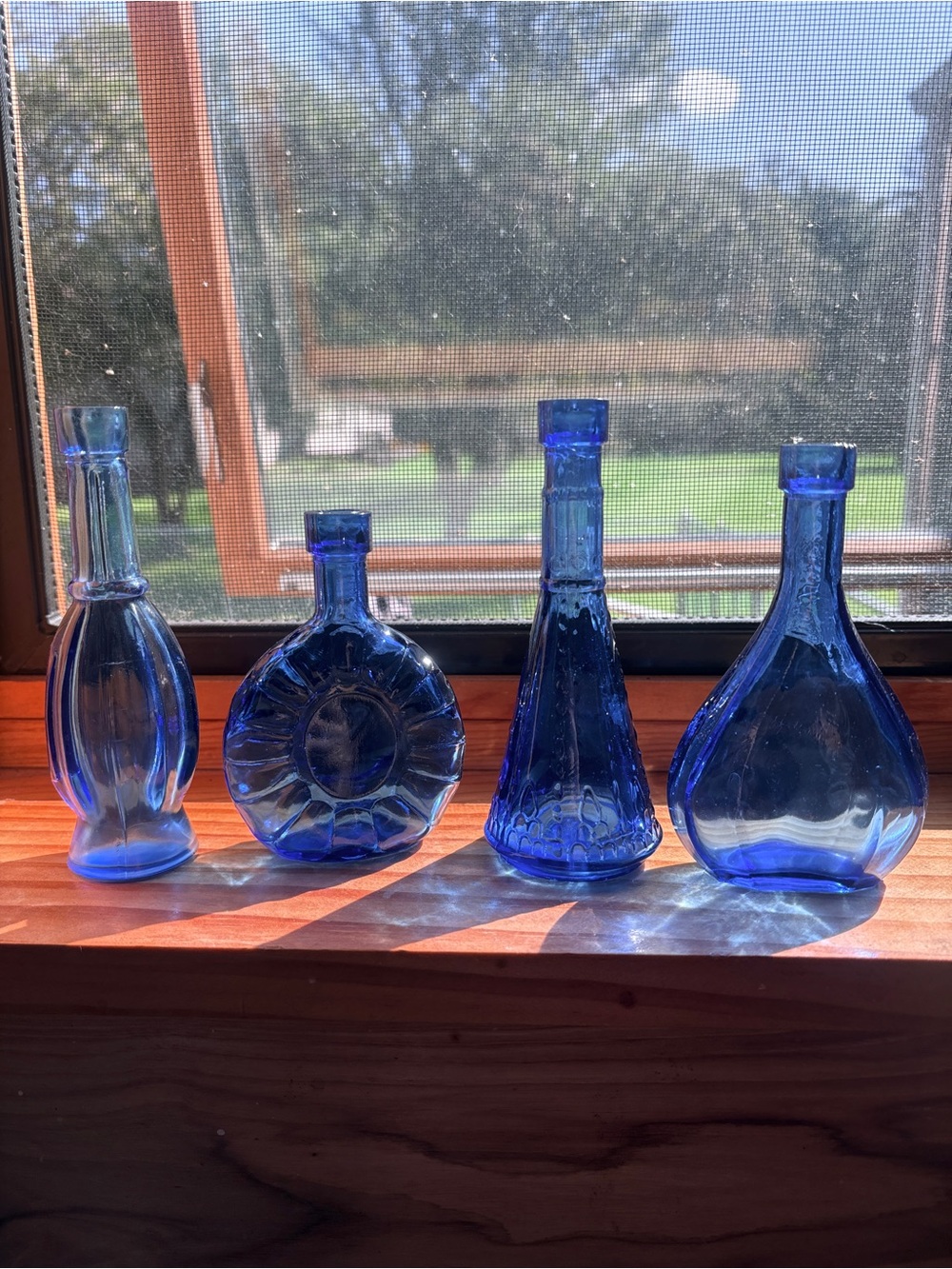 Mini blue glass vases (set of 4)